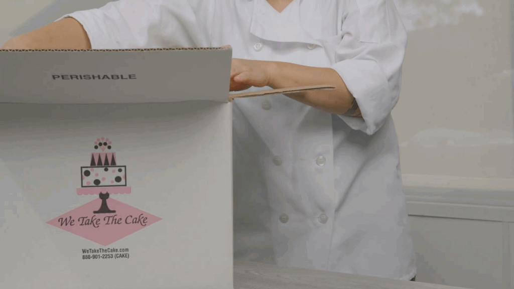Baker preparing a frozen cake for delivery with dry ice handling it safely